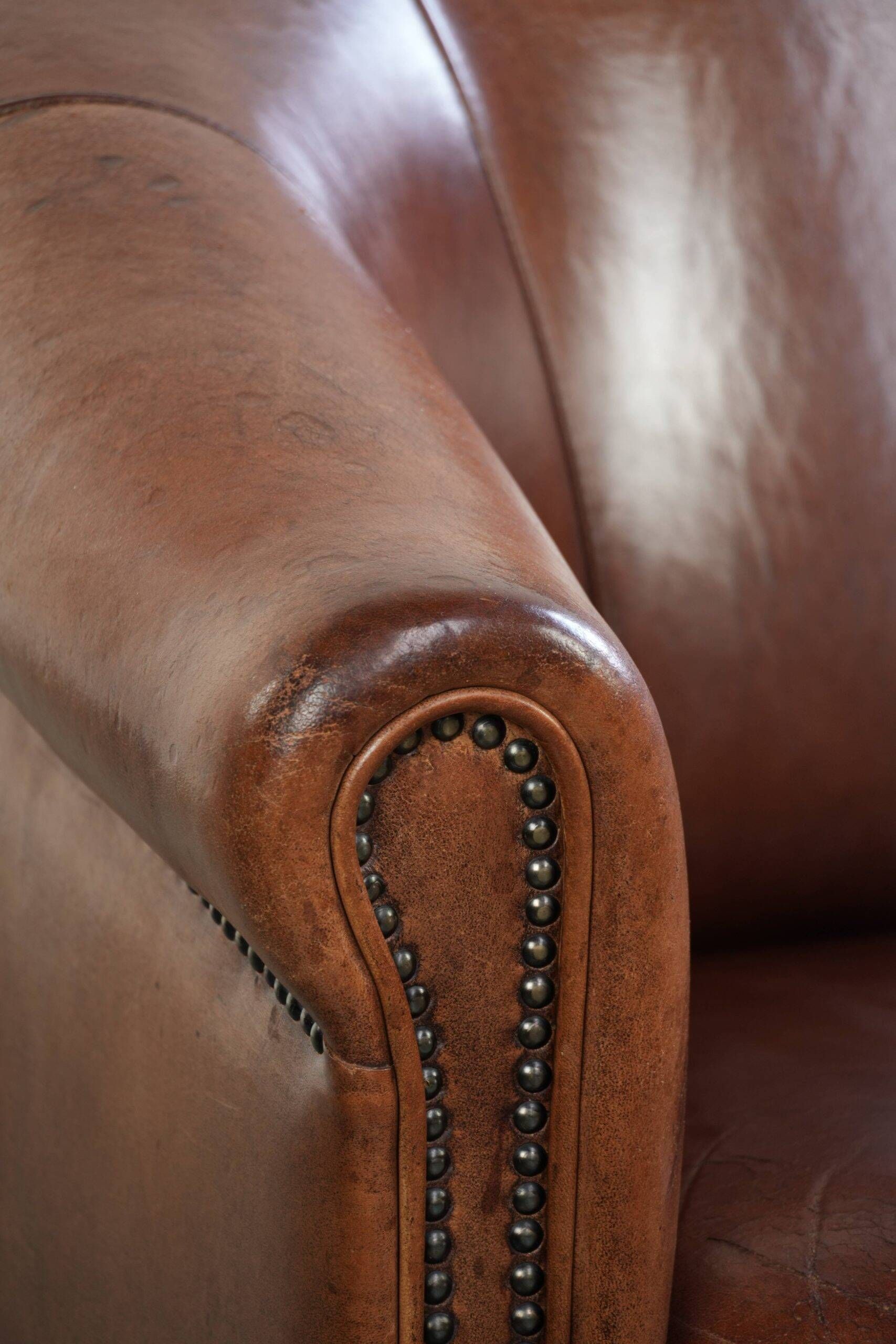 Vintage sheepskin club armchair in English style with deep colours