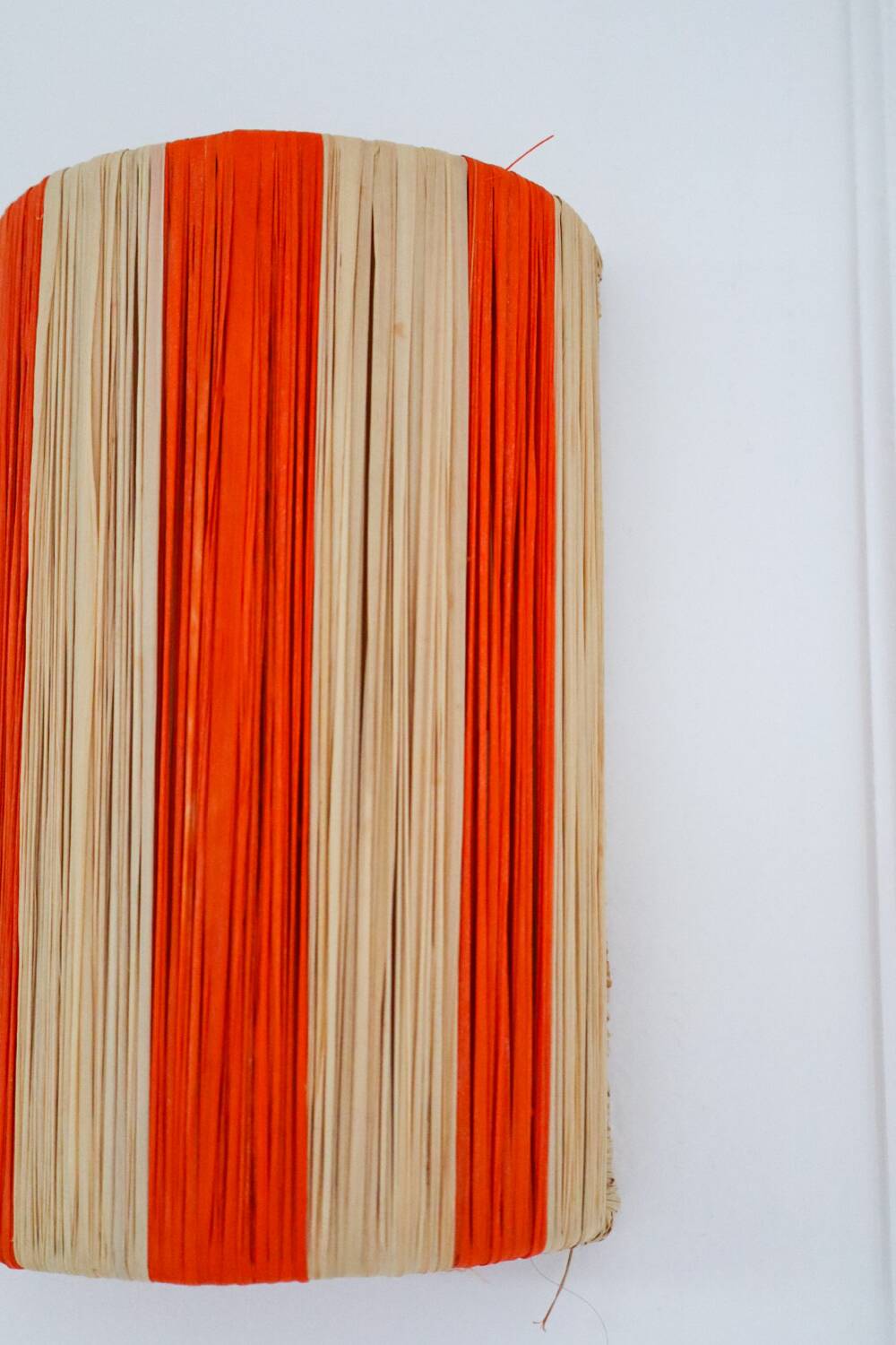 Orange and natural striped raffia wall light