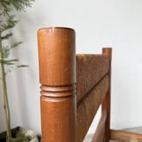 Brutalist style bed with chain and straw