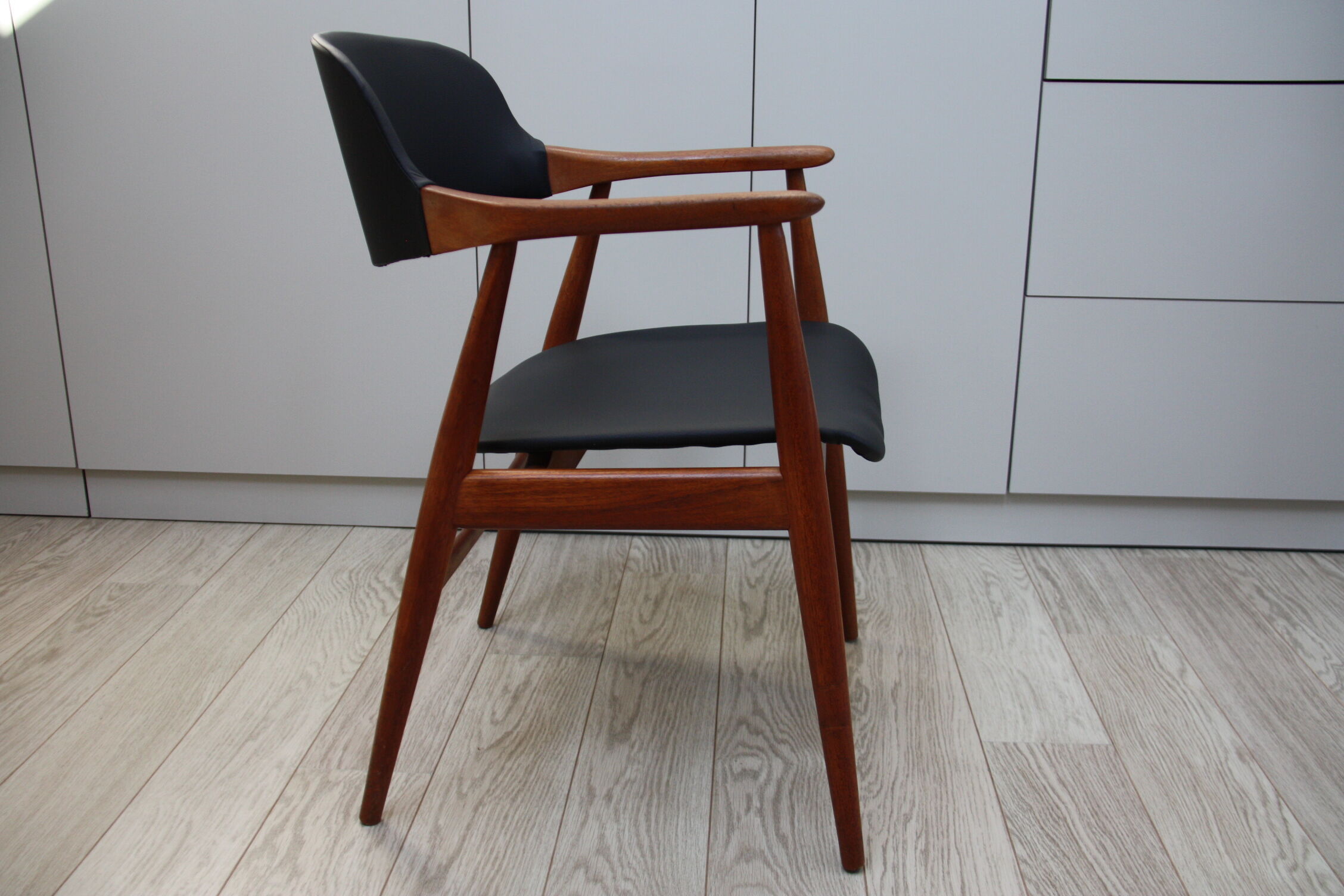 Vintage armchair in teak and black leather model Casina 60s
