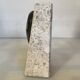 An asymmetrical travertine and fossil bookend.