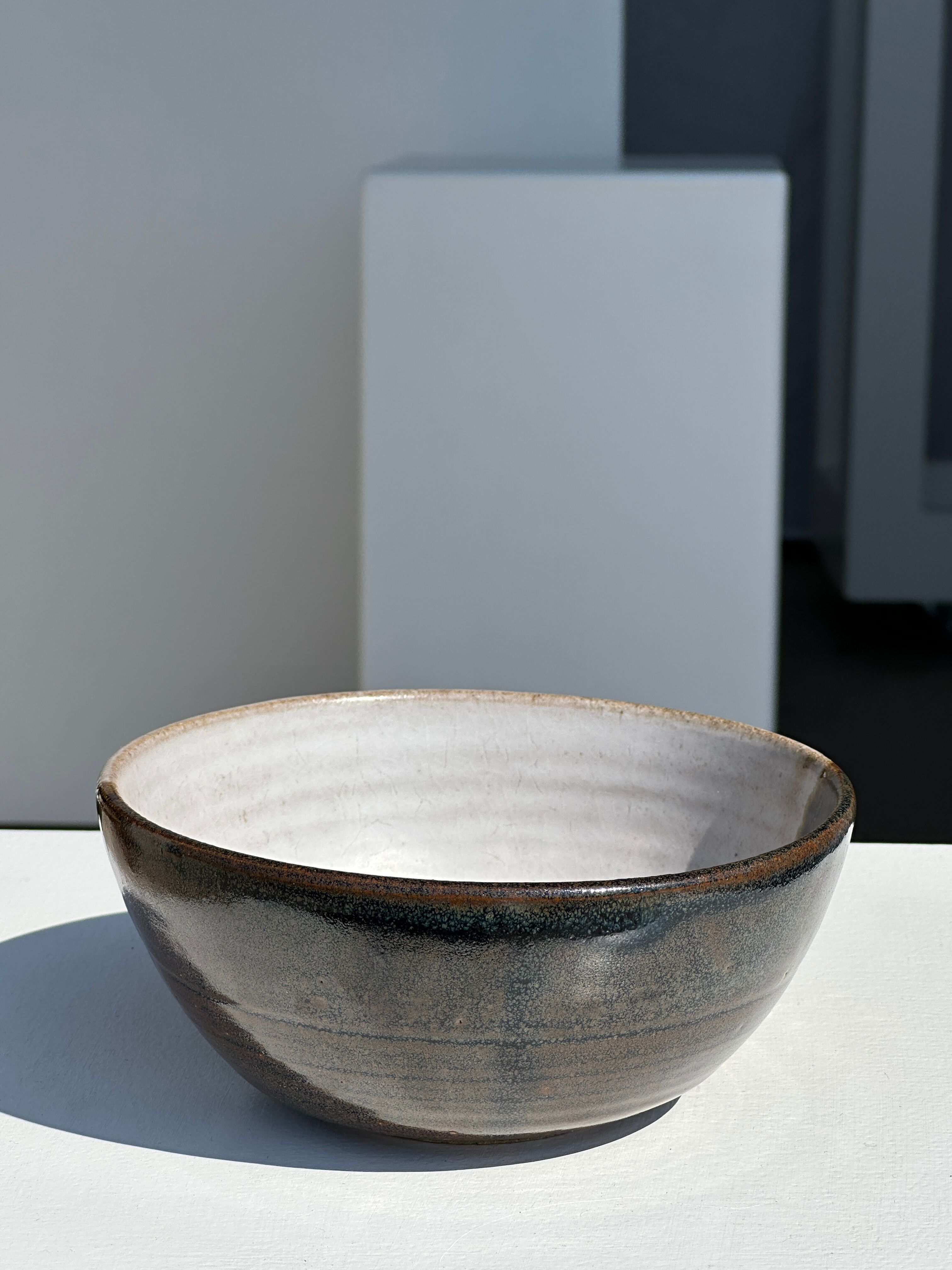 White and glossy brown two-tone ceramic bowl, matt earth