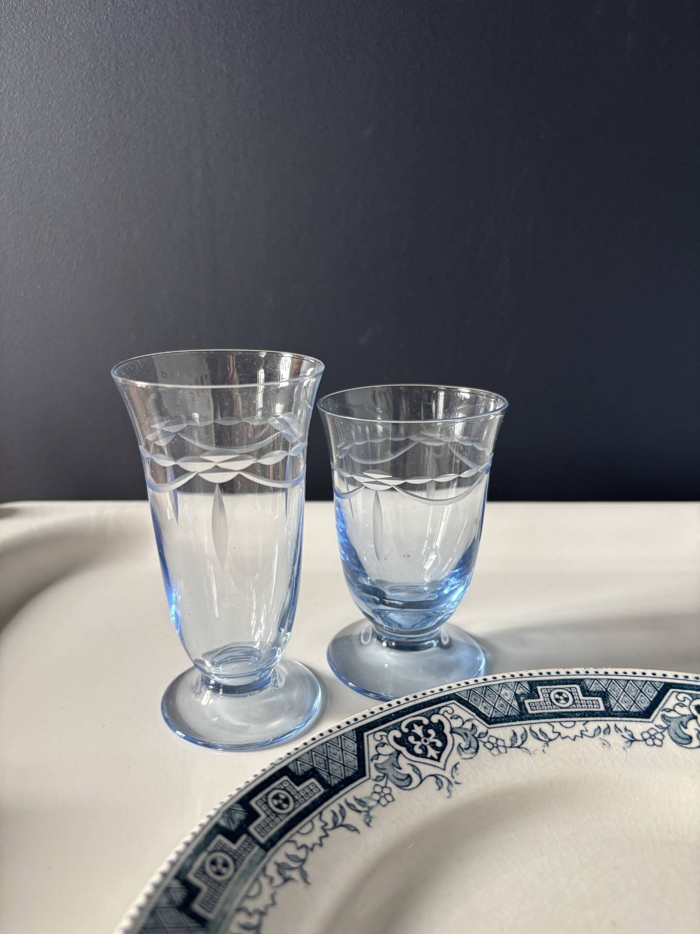 Set of 32 vintage glacier blue engraved stemmed glasses.