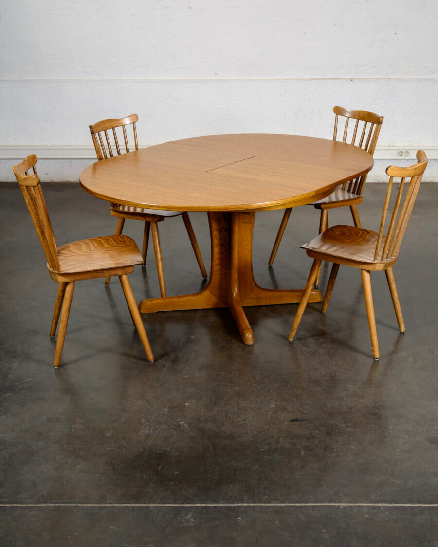 Round teak table with an extension.