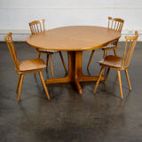 Round teak table with an extension.