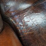 Cognac-colored vintage sheep leather wingback chair with character