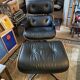 Black leather Eames Vitra armchair, original with rosewood ottoman.