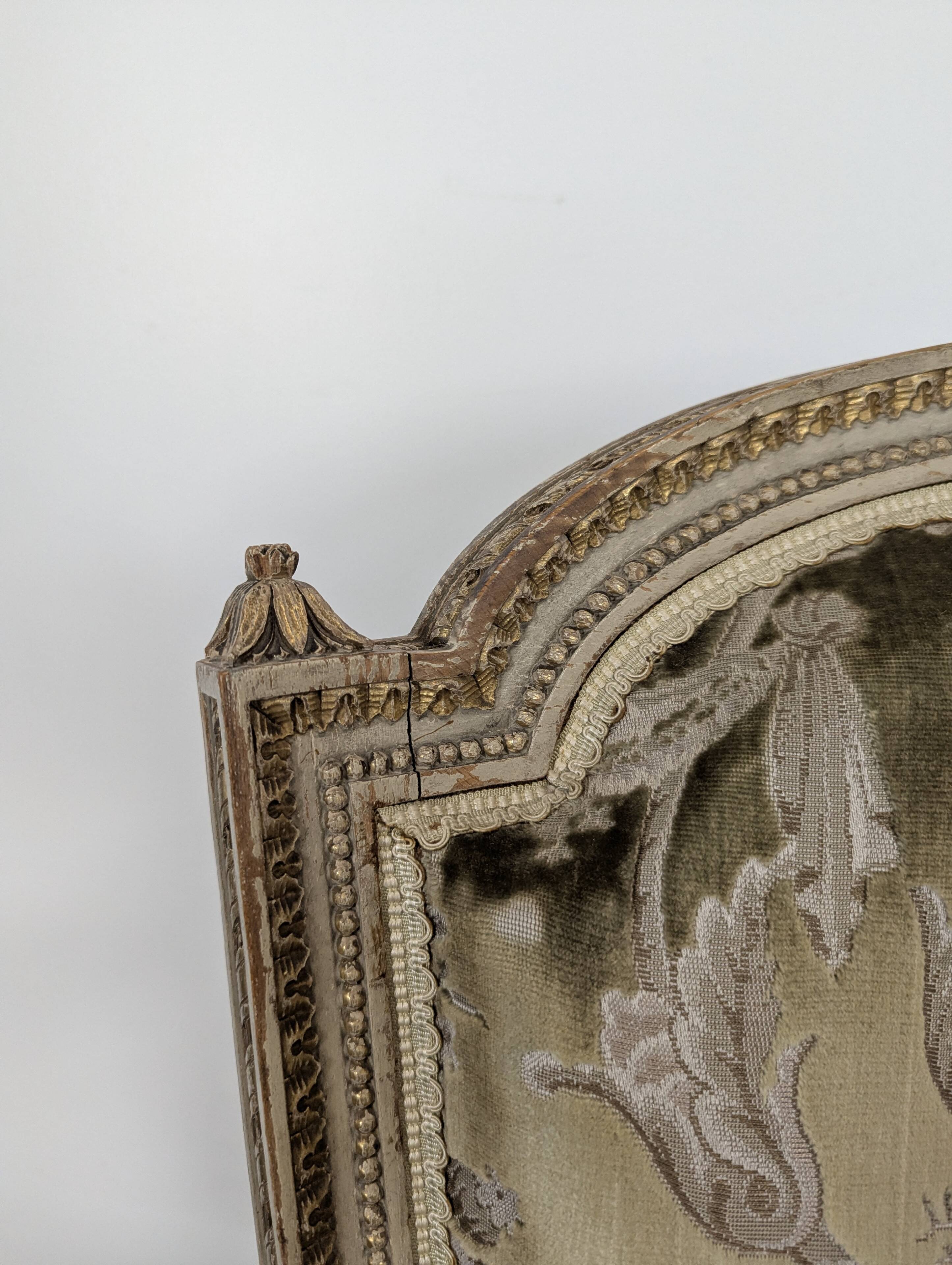 Cream lacquered Louis XVI style cabriolet salon with gold highlights.