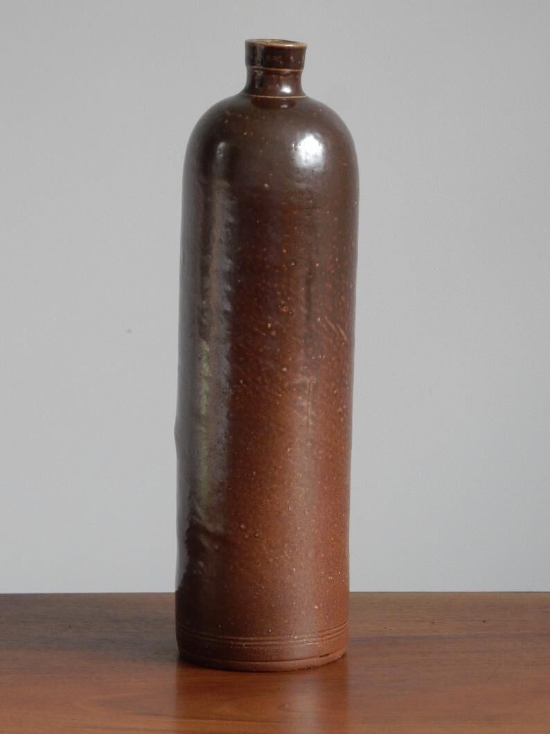 Enamelled brown sandstone bottle with handle