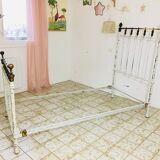 Old white metal and brass bed