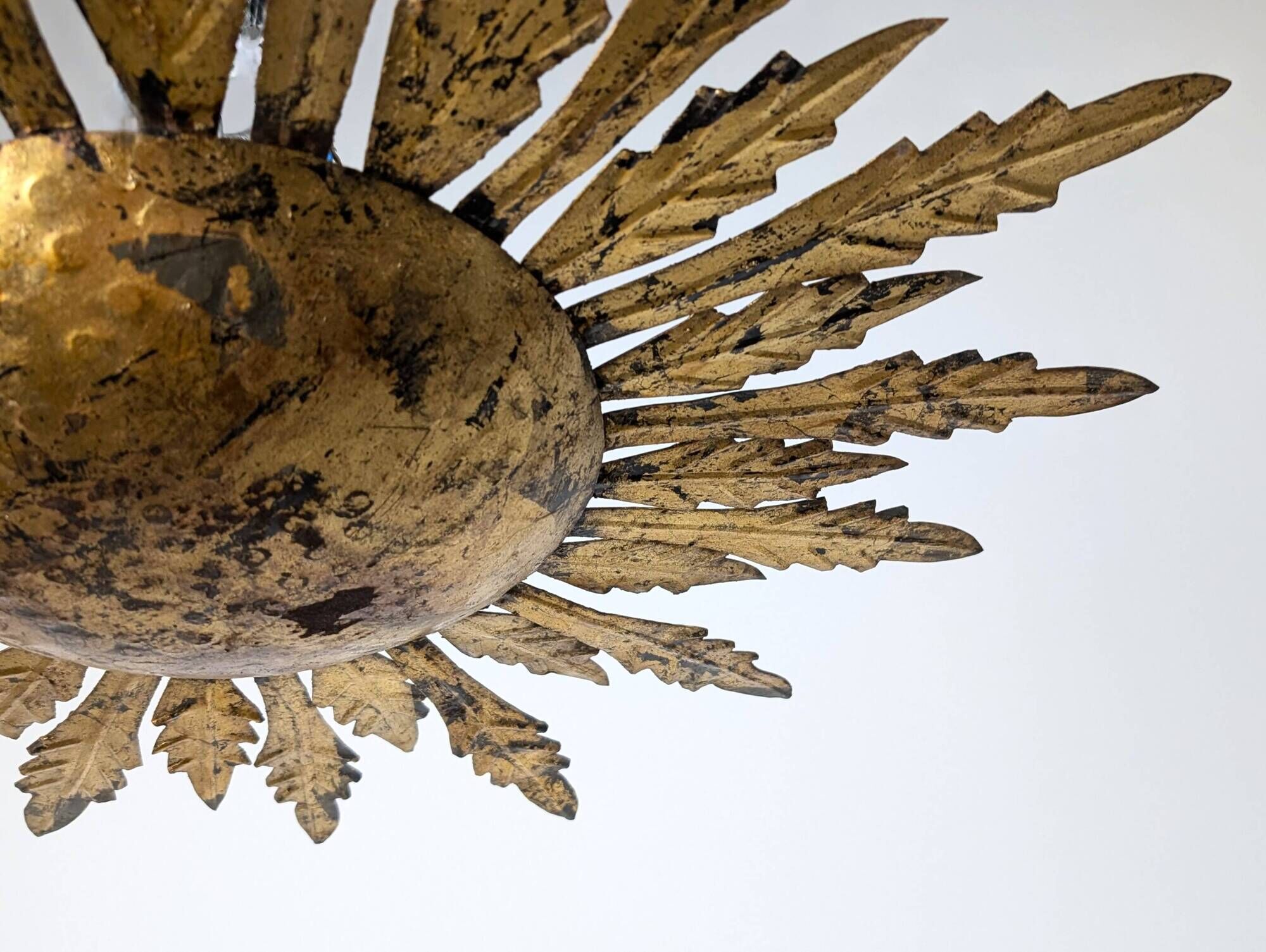 Mid-century sun ceiling lamp in gilded metal with leaf rays, 1950s