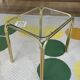 Pair of small nesting coffee tables in gold tubular metal & transparent glass tops