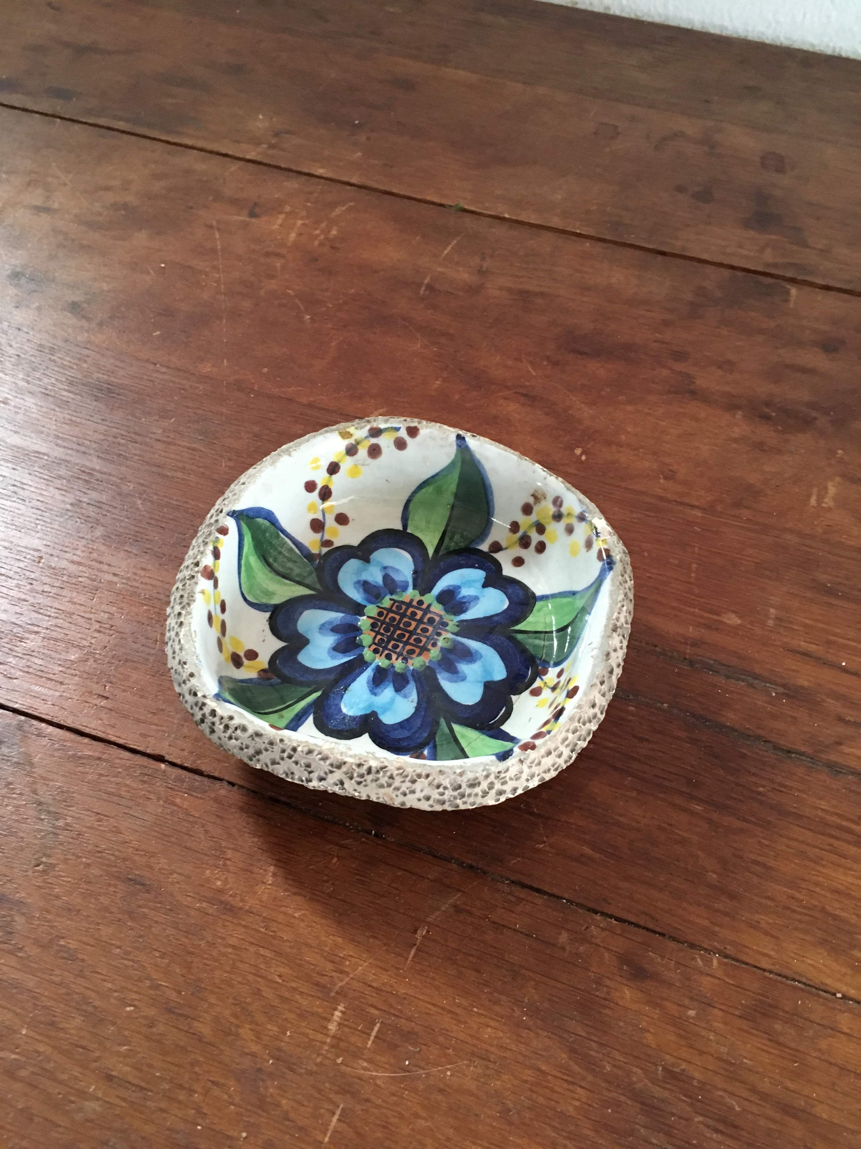 Cup lava foam with blue flower.