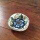 Cup lava foam with blue flower.