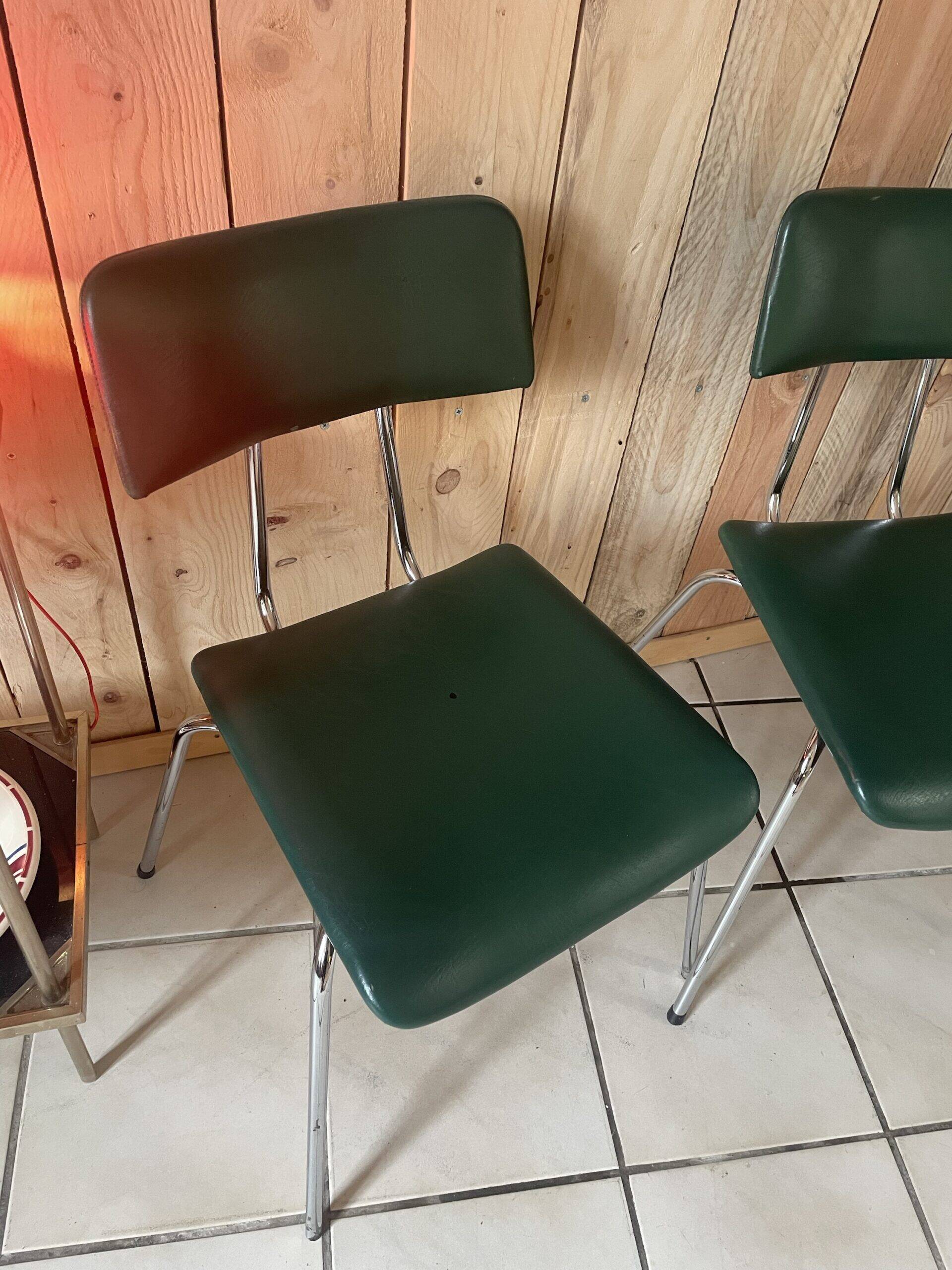 Pair of green faux leather chairs