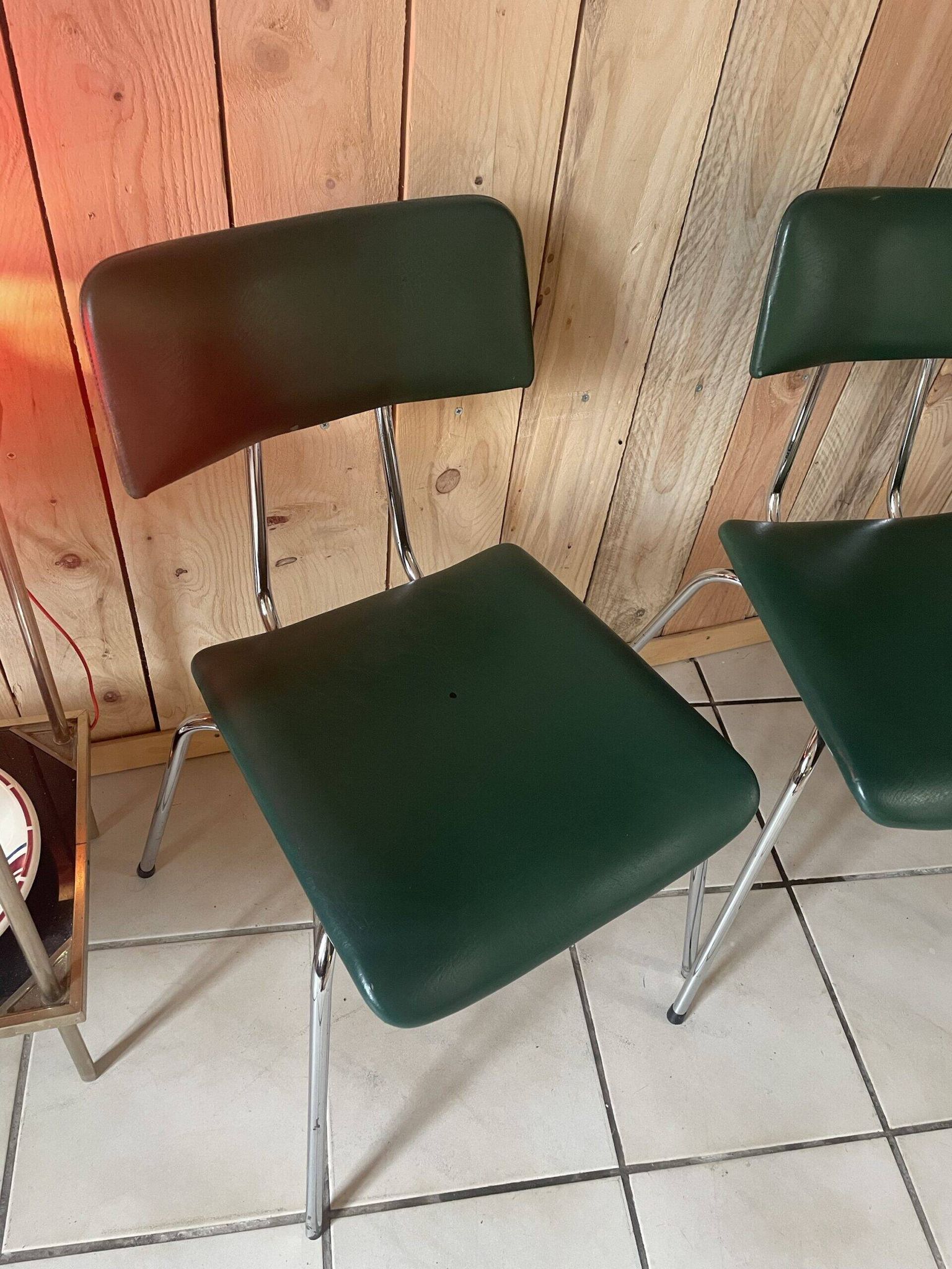 Pair of green faux leather chairs