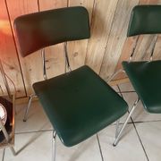 Pair of green faux leather chairs