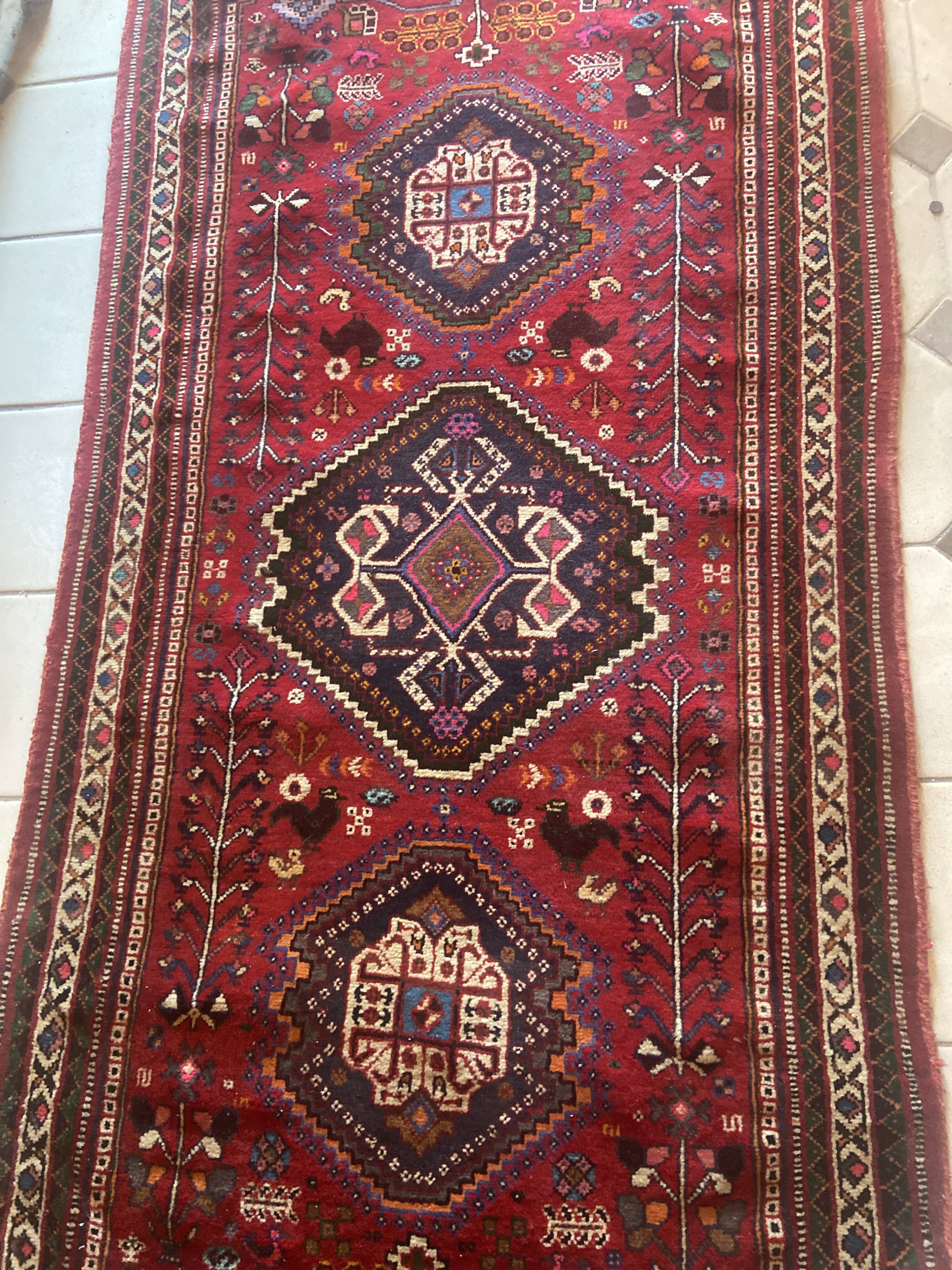 Large antique Oriental hallway carpet made of hand-knotted wool.
