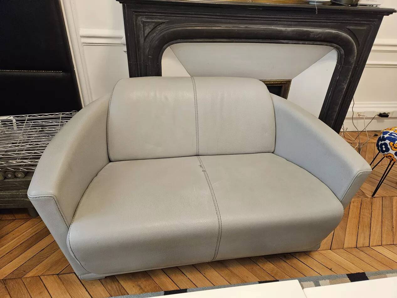 Two-seater sofa and a grey leather armchair Italia.