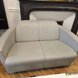 Two-seater sofa and a grey leather armchair Italia.