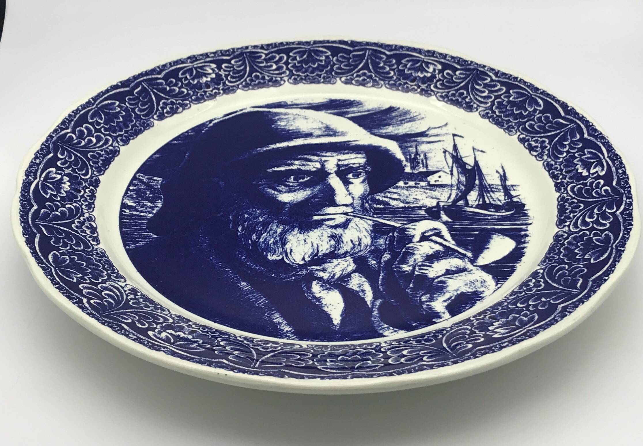 Blue enamelled earthenware wall plate with fisherman decor, Boch La Louvière, Belgium