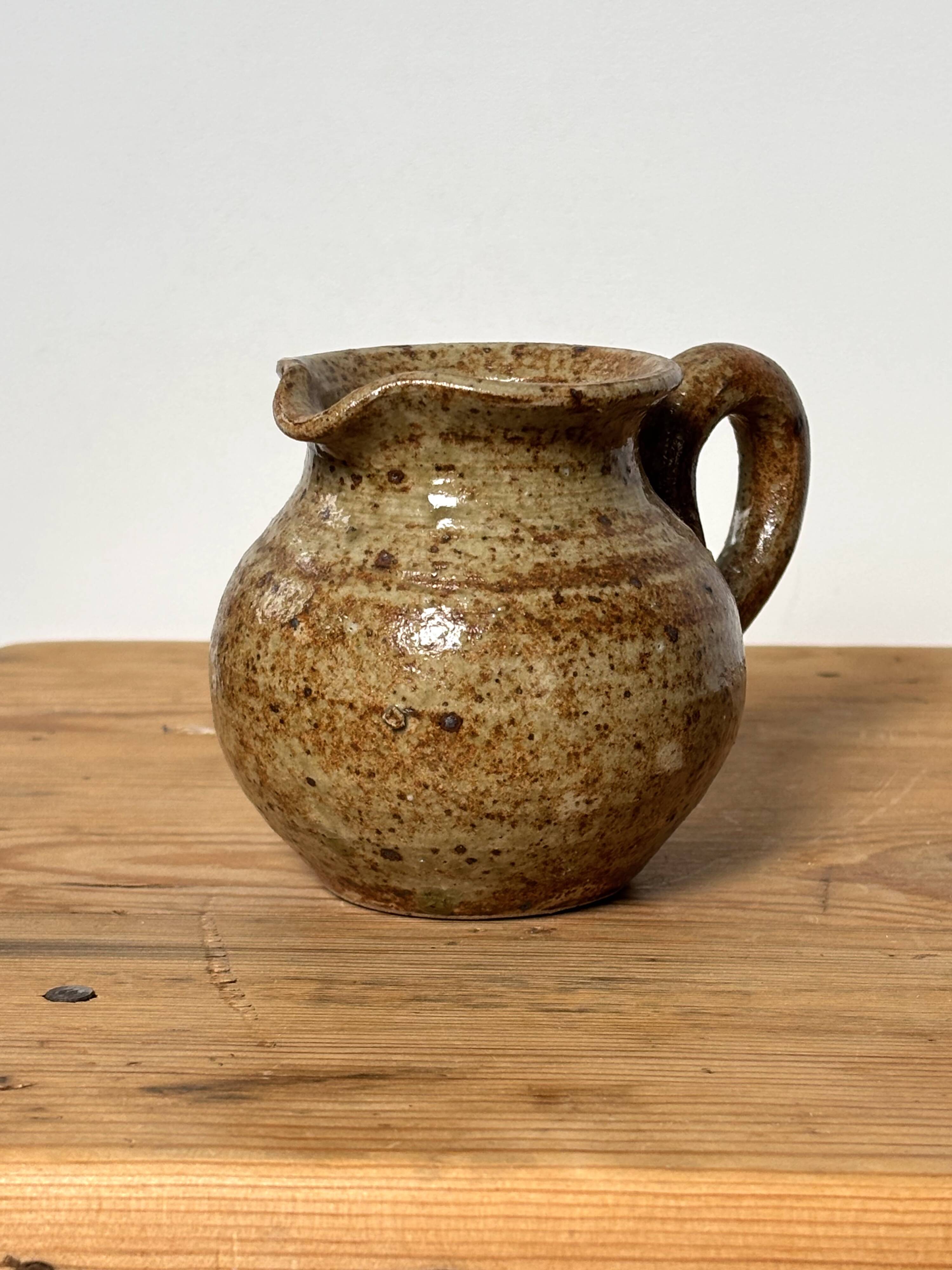 Small beige speckled stoneware pitcher