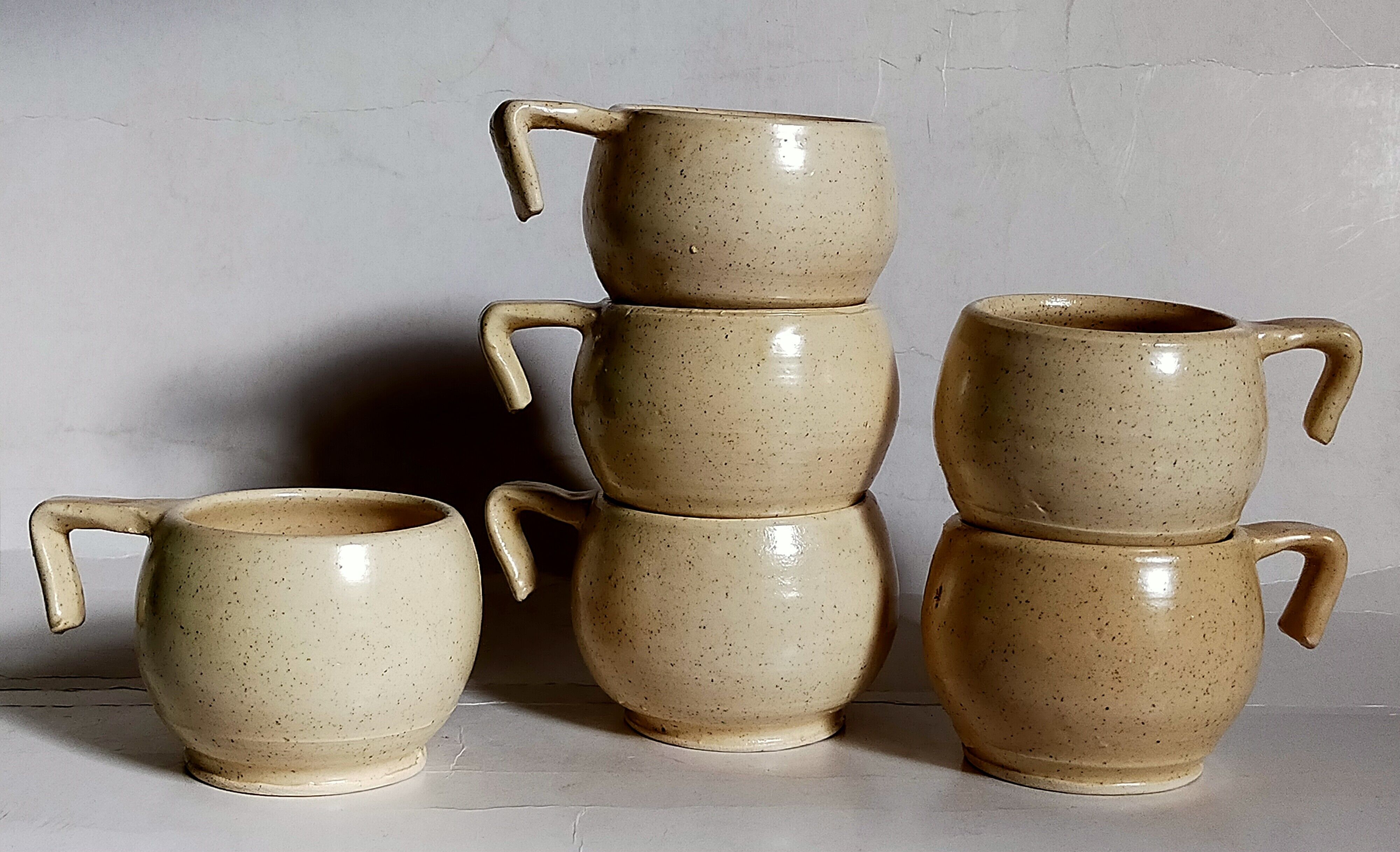 Six vintage potter's ceramic cups with vanilla enamel