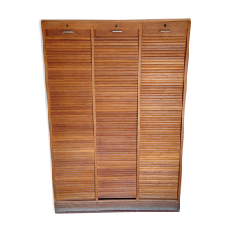 Filing cabinet has curtains, notary furniture. 3 columns
