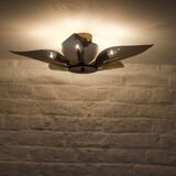 Ceiling light with perforated brass petals.