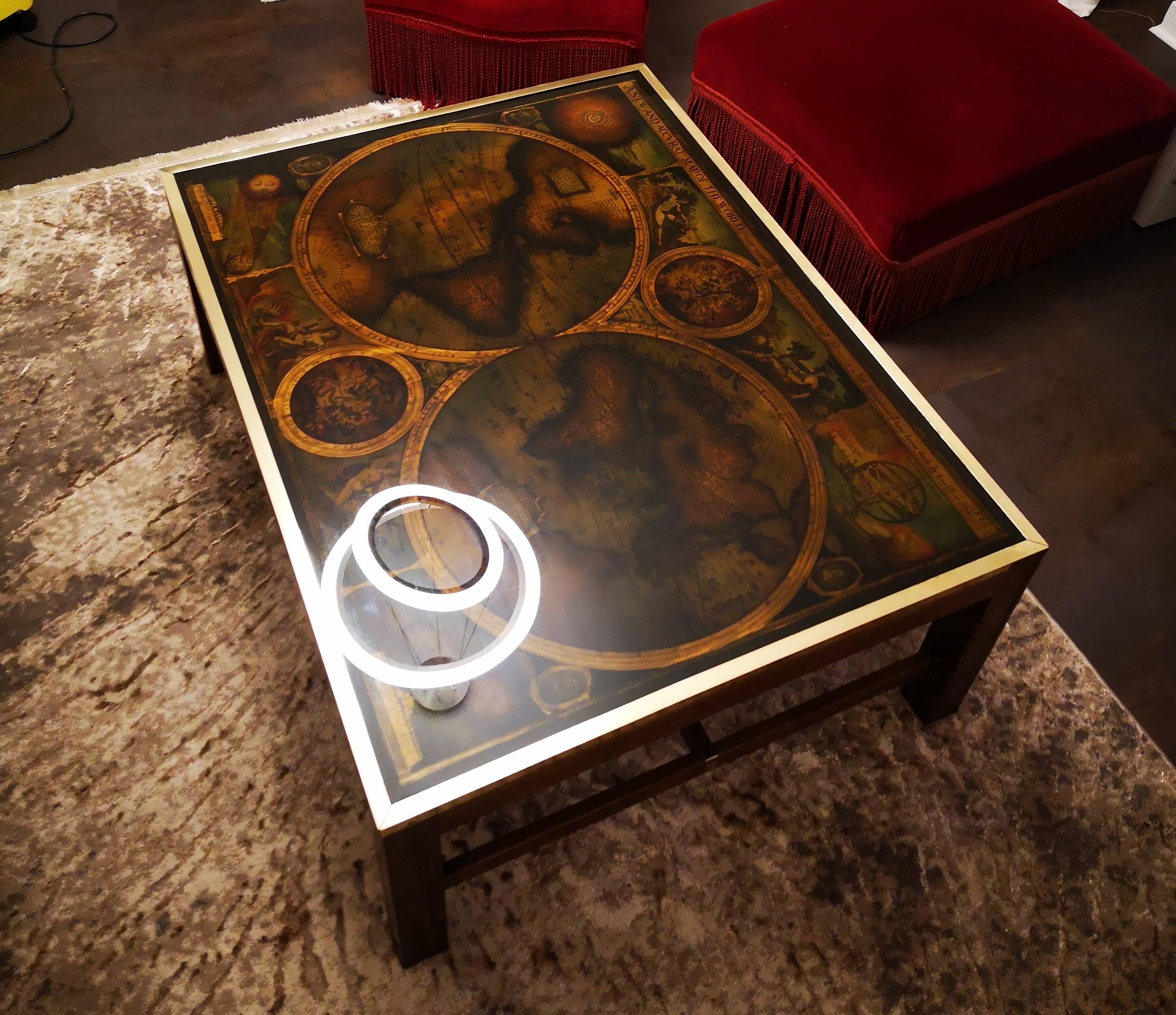 Coffee table in exotic wood, brass trim and planisphere under glass.
