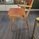 Modernist armchair in wood and orange fabric