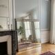 Large industrial-style mirror with glazing bars.