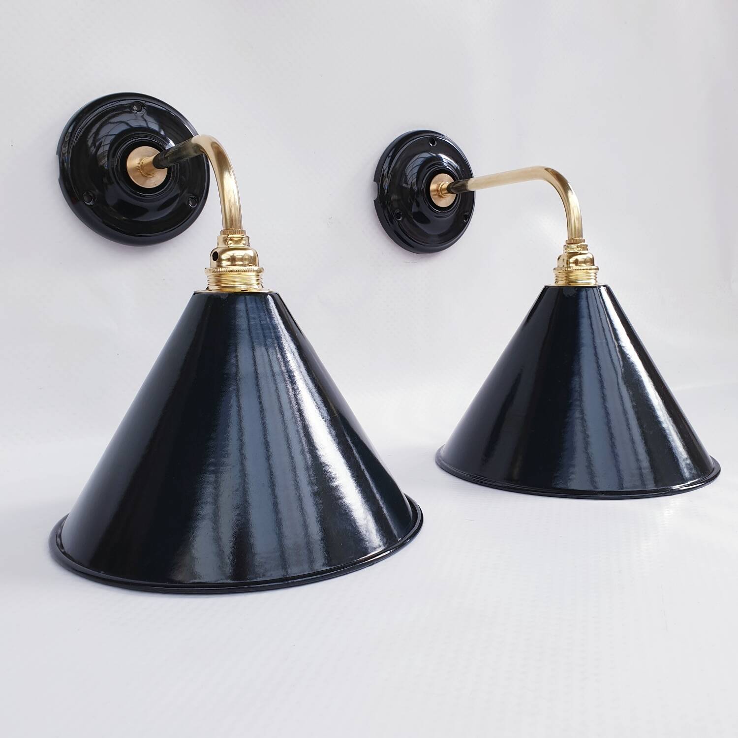 Pair of antique black enamelled sheet metal wall lights