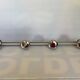 Chromed metal coat rack with four hooks