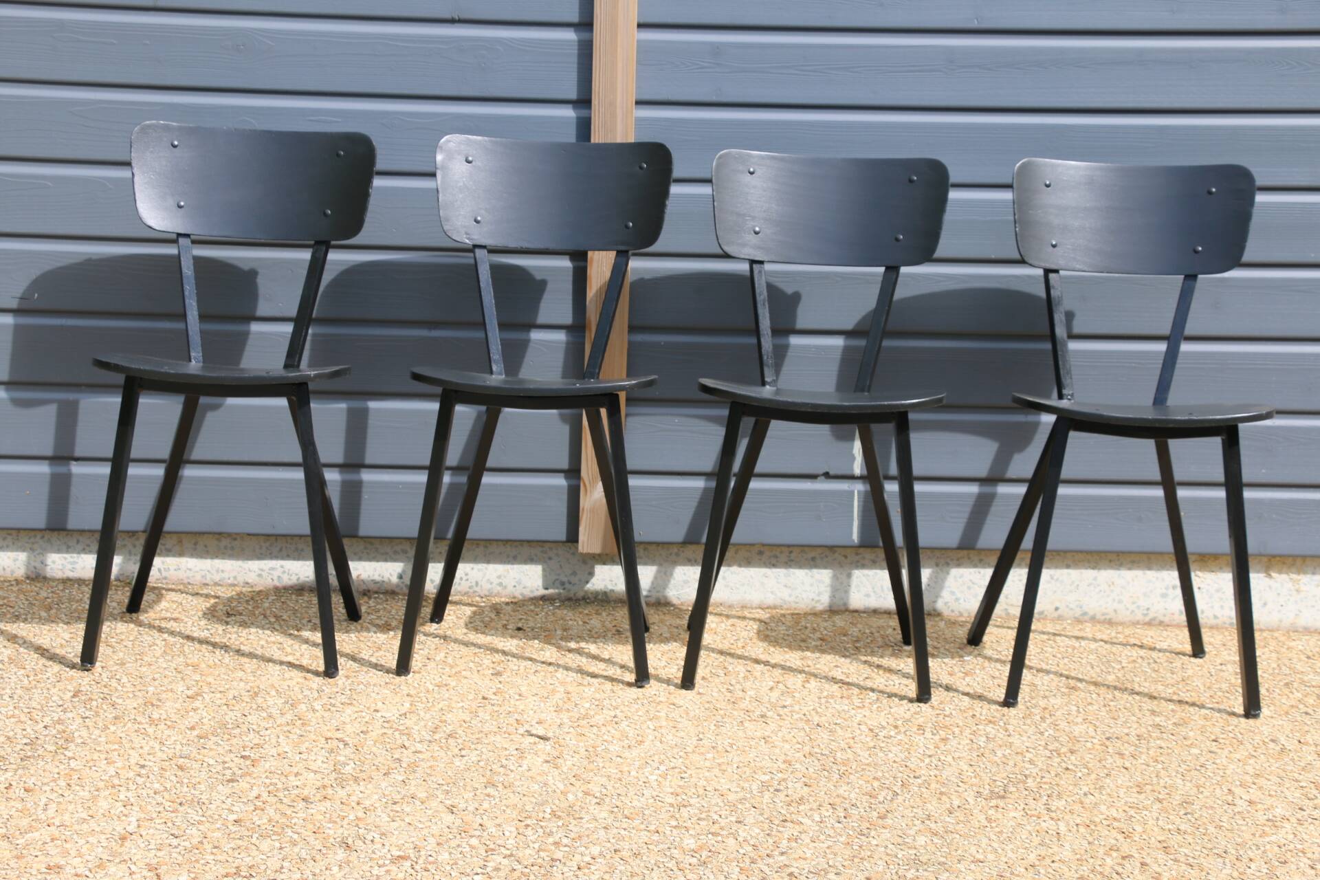 4 black metal and wood chairs