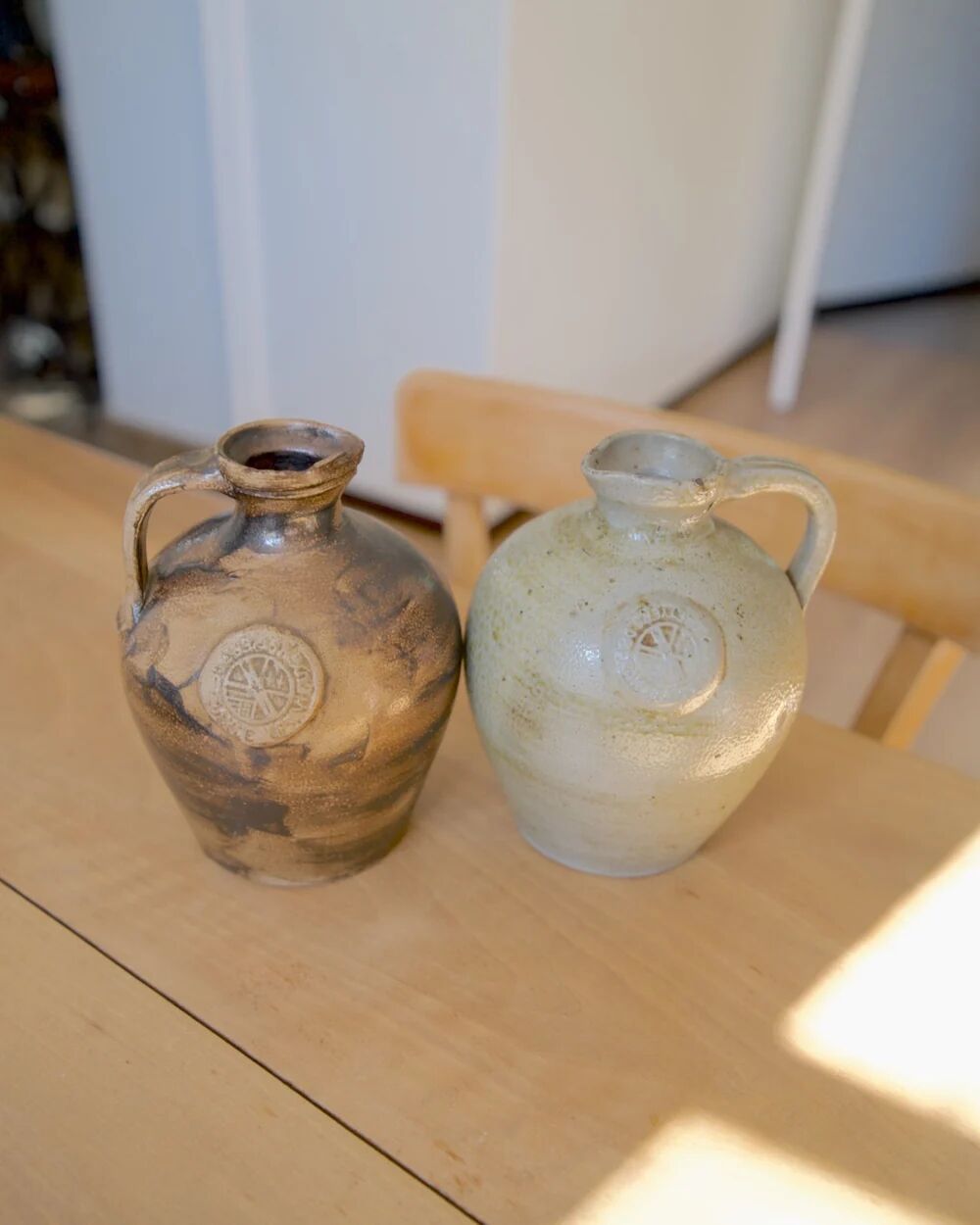 Duo of brown and cream ceramic jugs