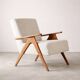 Mid-century modern armchair in solid wood and light beige fabric.