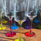 Champagne coupes in glass, multicoloured stems.