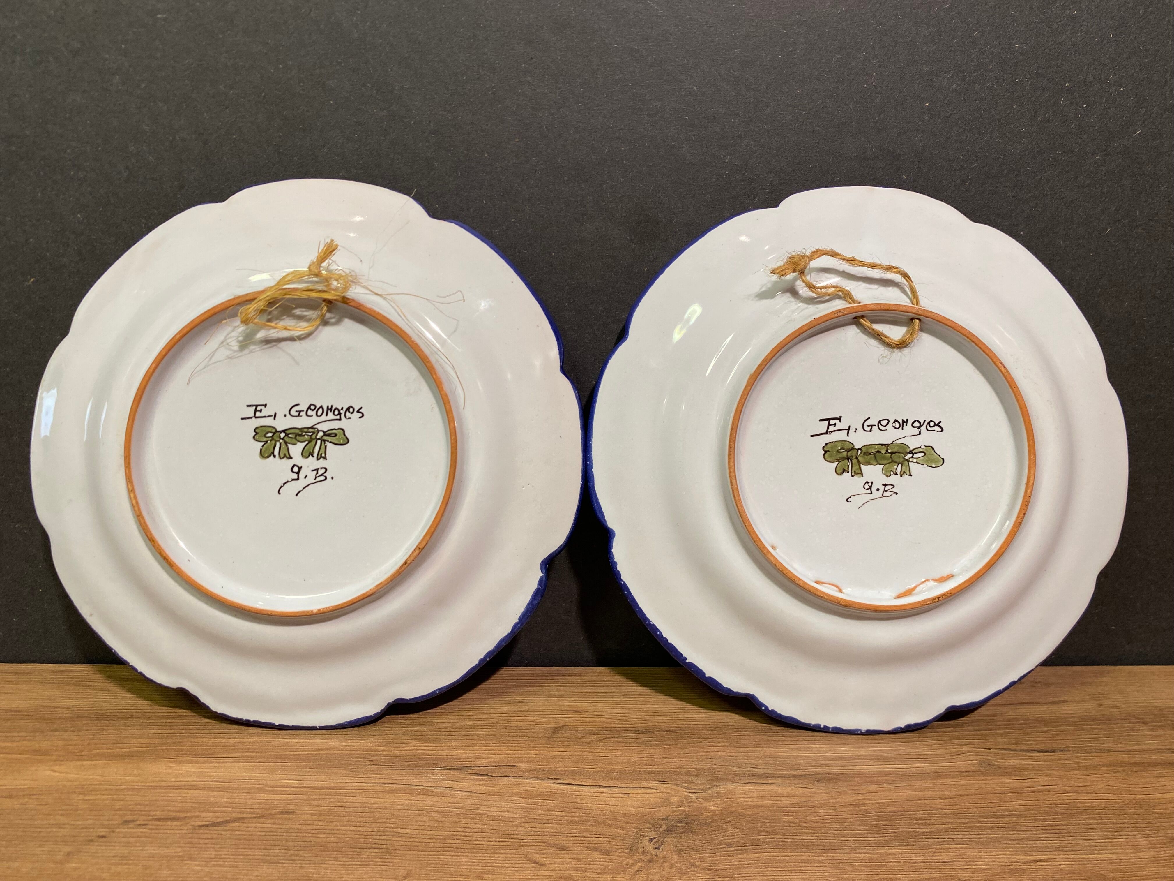 Pair of Nevers earthenware plates signed Georges
