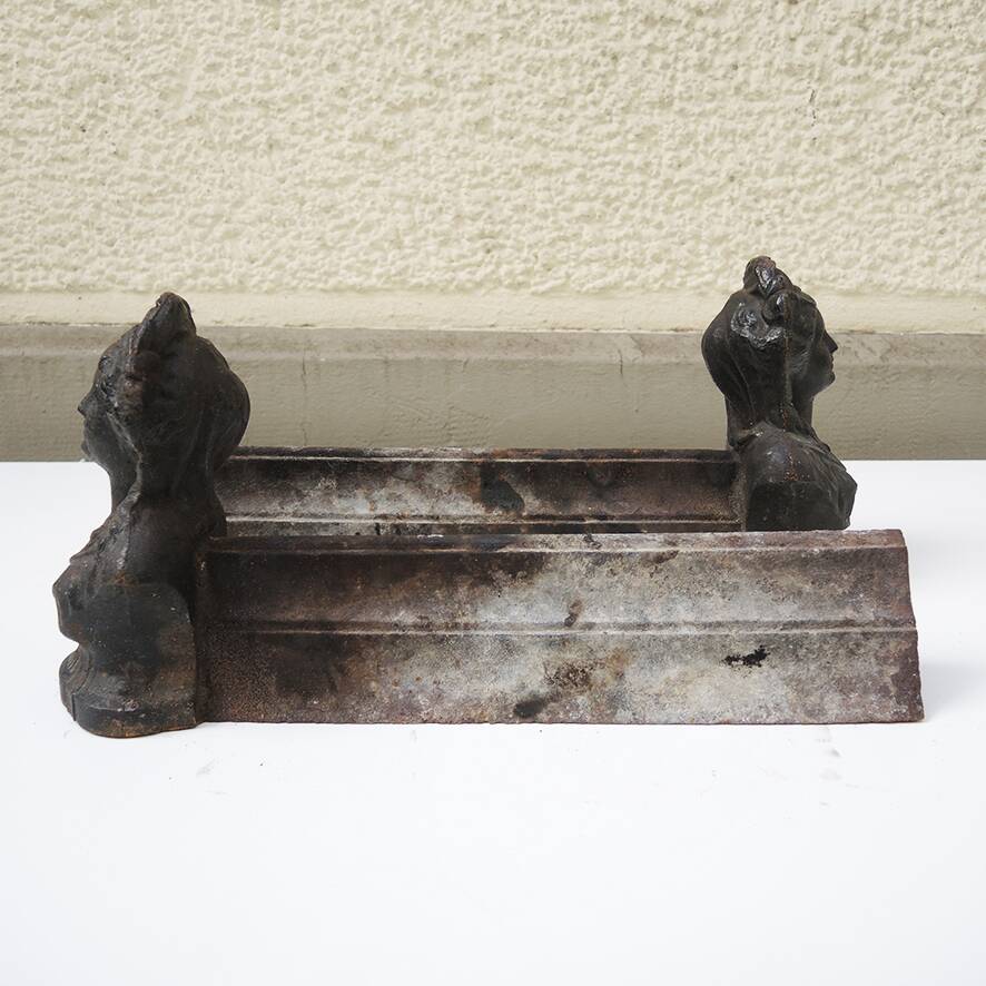 Old cast iron andirons: bust of a woman with a medallion
