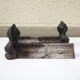Old cast iron andirons: bust of a woman with a medallion