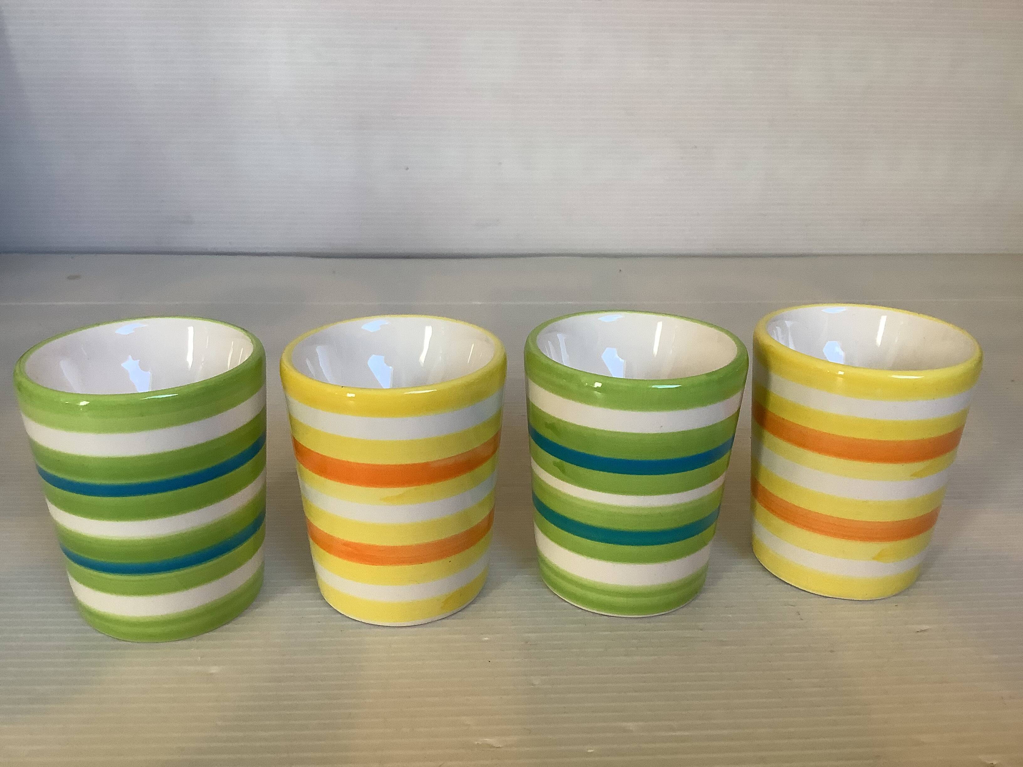 Four striped egg cups in yellow and green.
