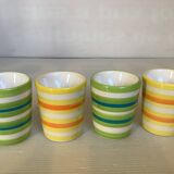 Four striped egg cups in yellow and green.