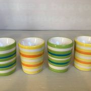Four striped egg cups in yellow and green.