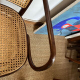 Curved wood and cane armchair