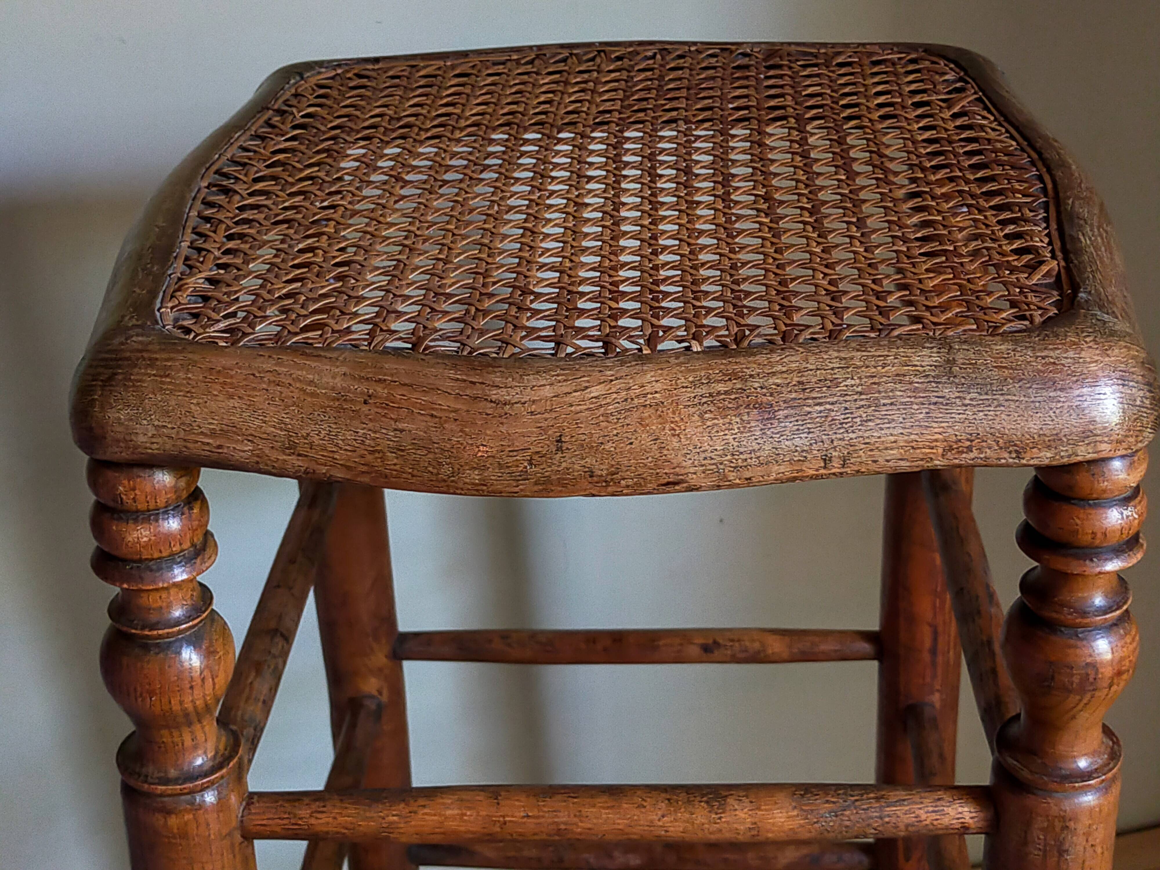 Antique stool with cane and turned wood