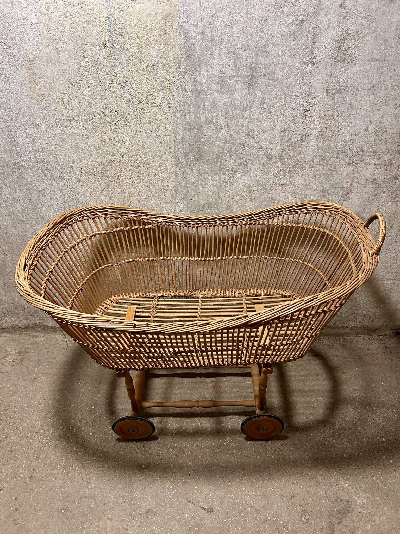 Vintage wicker cradle on wheels