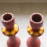 A pair of glazed earthenware candlesticks.