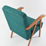 Green curved armchair