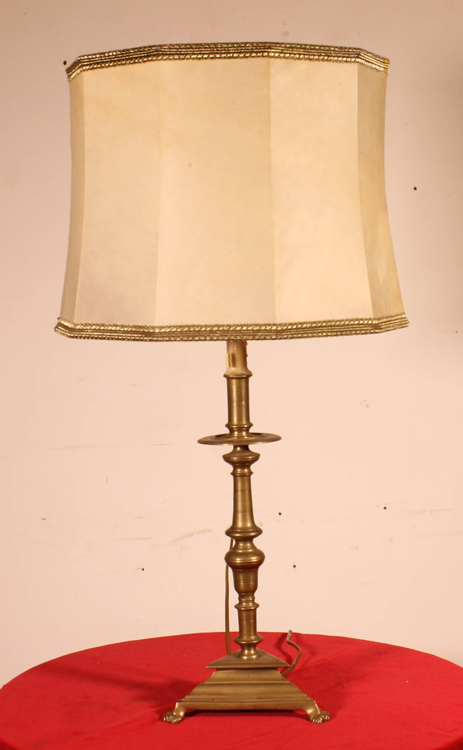 bronze candlestick from the 17th century converted into a lamp with its lampshade